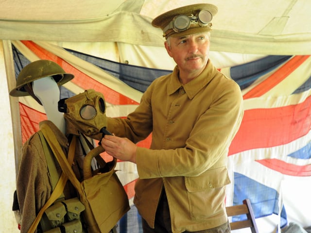 Peter Birkett with gas masks and First World War equipment