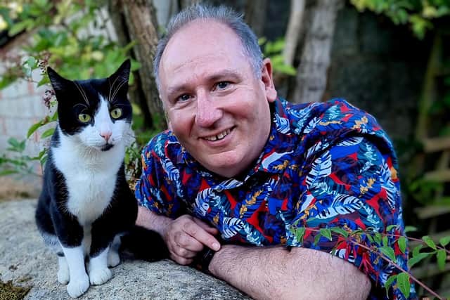 John May, the new chief executive of Cat's Protection, with his black- and-white rescue cat Blenheim