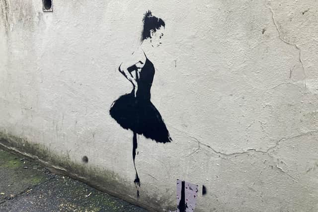 The Banksy-style mural on the side of a building in Horsham town centre