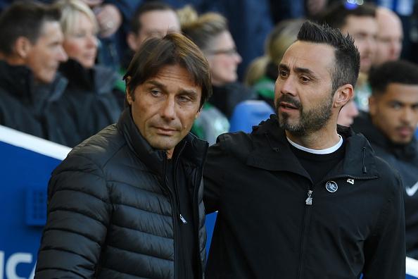 Antonio Conte, Manager of Tottenham Hotspur speaks to Roberto De Zerbi