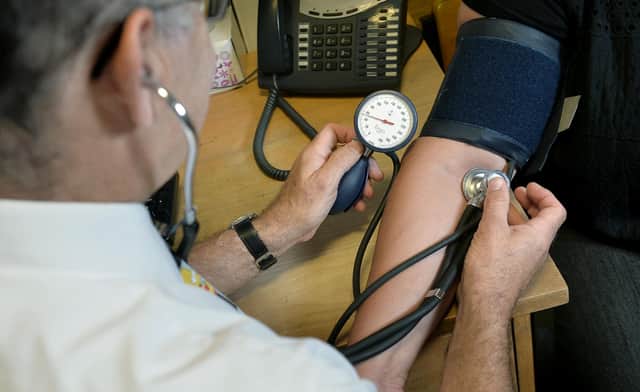 Dr Laurence Buckman checks a patient's blood pressure in his practice room at the Temple Fortune Health Centre GP Practice near Golders Green, London.