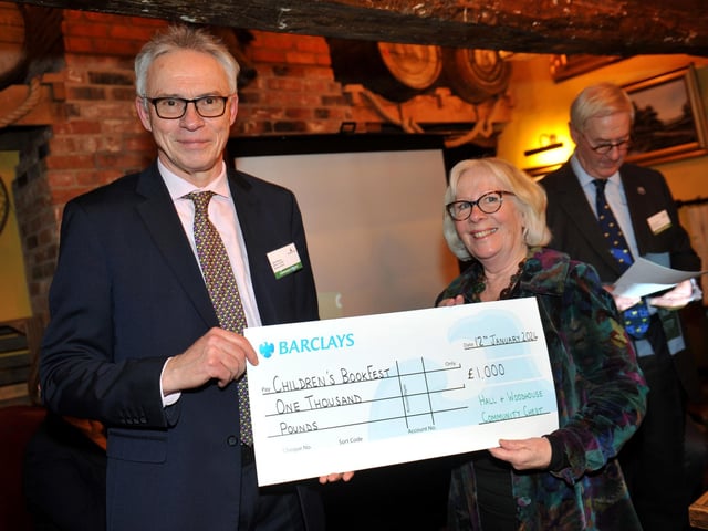 Judge Gary Shipton presents a cheque for £1,000 to Children's BookFest