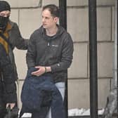 US journalist Evan Gershkovich (R), who was detained last March on spying charges during a reporting trip to the Urals, is escorted out of the Lefortovsky Court building in Moscow on January 26, 2024.