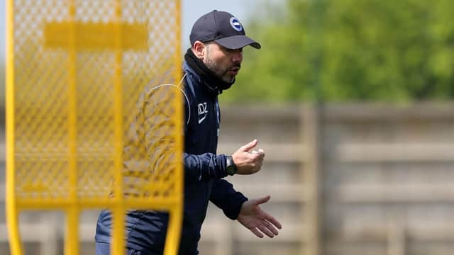 Brighton head coach Roberto De Zerbi keeps a close eye on his players during training