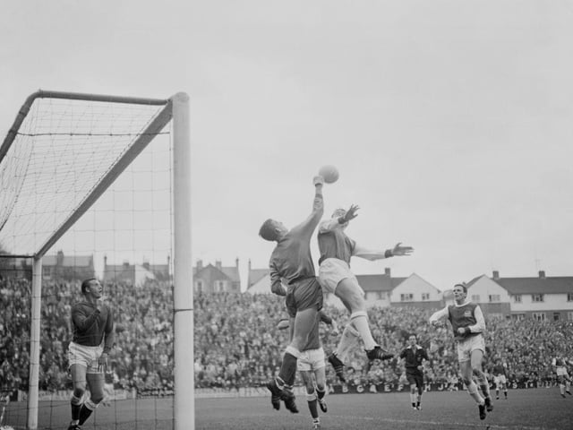 Brighton's Charley Livesey clashes with goalkeeper Alex Stepney during a game with Millwall on 25th September 1965. Stepney would go on to win the European Cup with Manchester United.