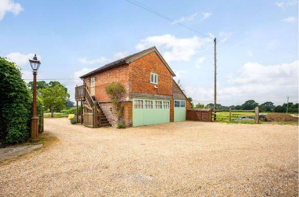 A detached former granary has been converted to provide ancillary accommodation. The ground floor garaging has triple garage doors; the first floor studio is approached by an external oak staircase and comprises a vaulted open-plan living room/bedroom with an attractive shaker-style kitchen to one end and ladder access to an open mezzanine, and a Lefroy Brooks shower room.