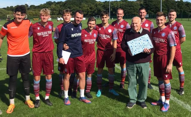 Little Common players present fan Pete Burton with a card and gift for his 90th birthday