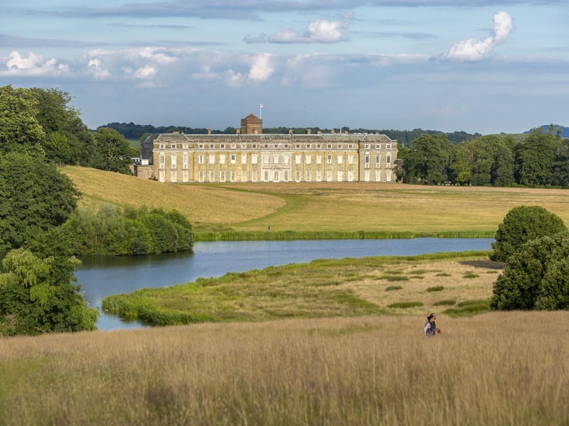Visitor in the grounds of Petworth House and Park, West Sussex.:Elmer's Art Parade at Petworth runs until September 3