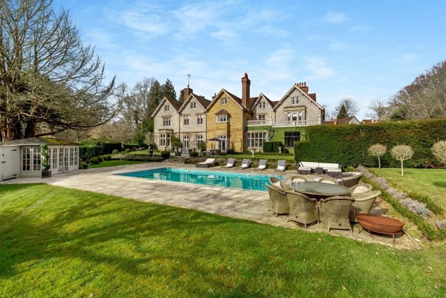 The garden offers an expansive area of paved terracing and a heated swimming pool