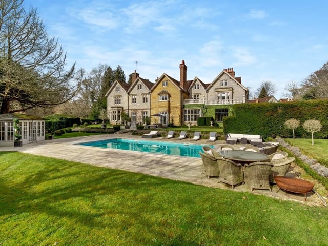 The garden offers an expansive area of paved terracing and a heated swimming pool