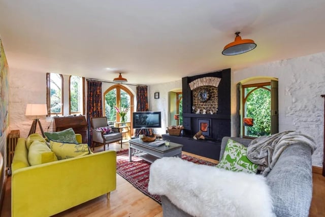 There is an L-shaped triple aspect sitting/dining room with feature fireplace and inset woodburner, wooden flooring, ornate radiators, arch doorway leading through to the elegant orangery with tiled flooring and double doors leading out to the landscaped rear gardens. Picture: Zoopla