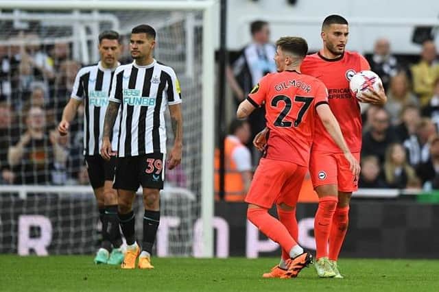Brighton's German striker Deniz Undav (R) celebrates after scoring at St James' Park