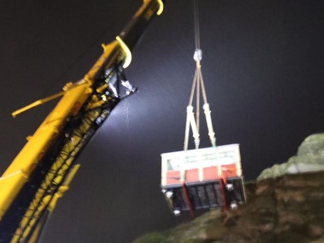 A carriage being hoisted out by crane