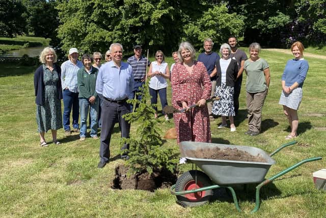 Lady Emma Barnard, her husband James and members of the Parham team planting the cedar in the Pleasure Grounds at Parham House, near Pulborough, West Sussex.