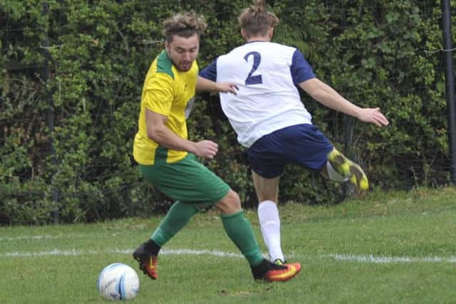 Callum Smith turns away from an Upper Beeding defender. Picture by Simon Newstead