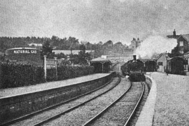 Though the quality of this image is poor, the gasometer storing natural gas extracted via a bore-hole close by Heathfield railway station can be clearly seen to the left of the platforms. The gas was used to illuminate the station from 1898 to 1930.