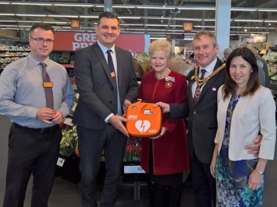 Outgoing mayor of Newhaven Steve Saunders presents a new defibrillator to Sainsburu's store manager Jason Howell. Joined by mayoress Sharon Bewley and  former High Sheriff Juliet Smith DL