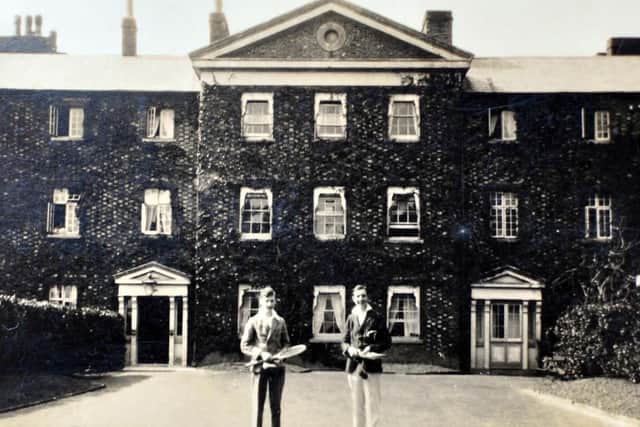 Anyone for tennis? Two players outside the Cuckfield Workhouse/Hospital building