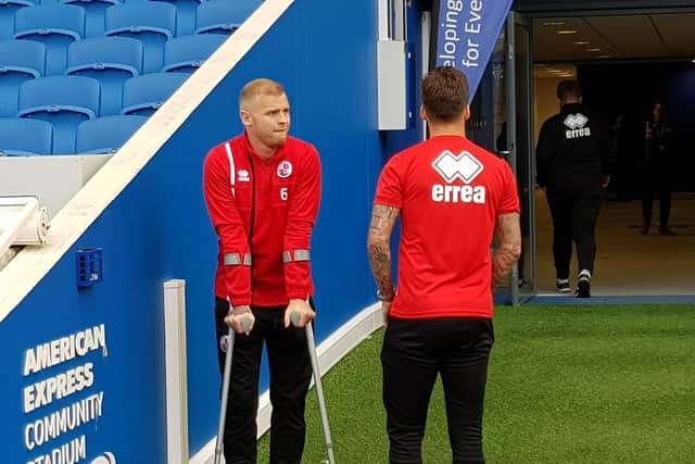 Injured Crawley Town players Mark Connolly, left on crutches, and skipper Jimmy Smith at the Amex