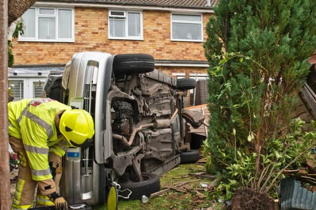 The car on its side in a garden in Burgess Hill yesterday (October 8). Picture: Eddie Howland