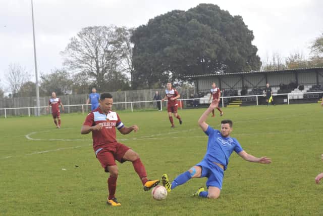 Shoreham's Scott Kirkwood competes with Little Common's Wes Tate for the ball. Picture by Simon Newstead.