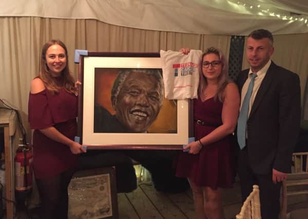 Sian Cooper, Chloe Woolfe and Ashley Woolfe with Noreen Denzils Madiba painting. SUS-171129-111211001