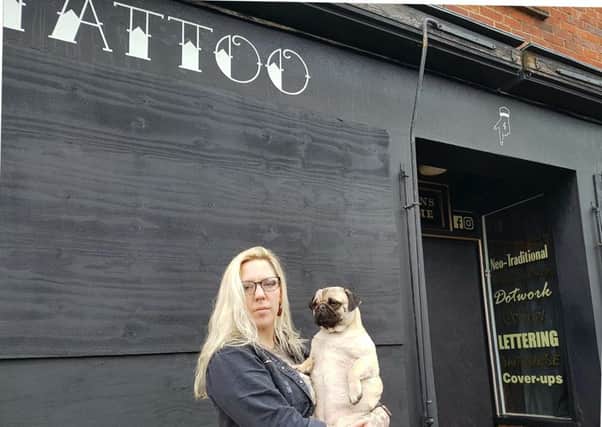 Leah Elphick, owner of the Black Pearl Tattoo Parlour, has decided to leave the shop boarded up after its windows were smashed.
