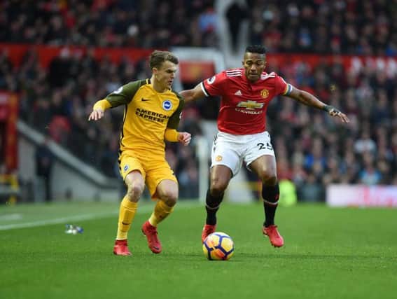 Solly March and Antonio Valencia battle for the ball as Brighton & Hove Albion took on Manchester United at Old Trafford. Picture by PW Sporting Pics