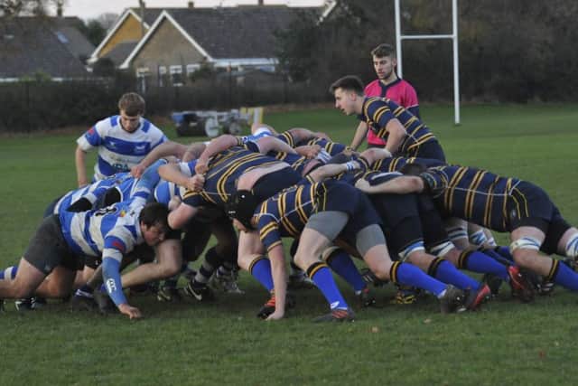 The two sets of forwards lock horns at a scrum.