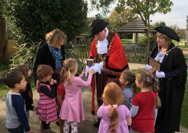 The Mayor and Mayoress present the cup for First Prize in the Chichester City Councils Schools Garden competition to Eve Robson, the teacher who led the garden project, and the children of Chichester Nursery School. From left to right: Henry, Ava-Rose, Darcey, Robyn, Macey-Mai, Phoebe and Kaja
