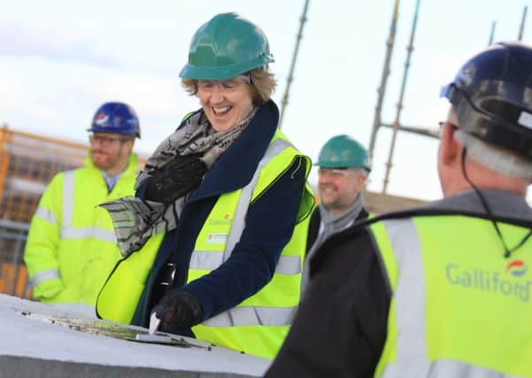 University vice-chancellor Professor Jane Longmore completes the last section of concrete for the new building
