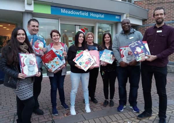Jade Wood, centre, presents advent calendars to staff at Meadowfield Hospital, for them to pass on to the patients