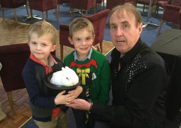 Children pictured with Robbie the magician at the party