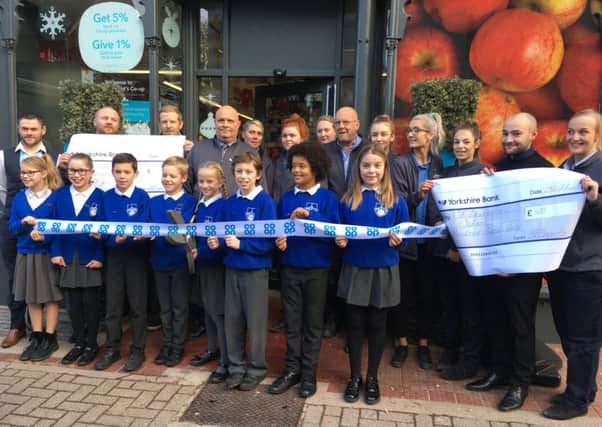 Schoolchildren at the re-opening of the Co-op store in High Street, Hurstpierpoint SUS-171129-160249001