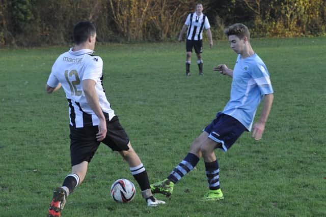 Crowhurst and Robertsbridge tussle for possession in midfield.