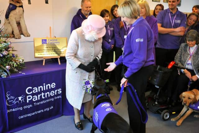 The Queen visited Canine Partners, Mill Lane, Heyshott, Midhurst she was presented with a bouquet of flowers by Yarna, seen here with Alison Bailey. Pic Steve Robards SR1728934 SUS-171130-130723001