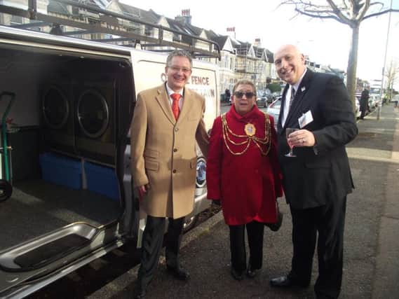 Landry Guillochon from Electrolux, which provides the washers and dryers for the vans, Brighton and Hove mayor Cllr Mo Marsh, and CEO of Off The Fence Paul Young, with the laundry van