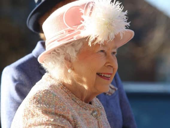 The Queen smiles as she visits the Chichester Festival Theatre