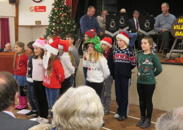 Pupils Little Common Primary School, accompanied by the Hooe Village Band, perform Carols at Little Common community centre. SUS-170512-112948001