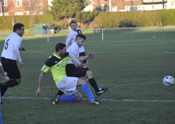 Bexhill United midfielder Kyle Holden goes in for a tackle during the 4-2 win at home to St Francis Rangers. Pictures by Simon Newstead