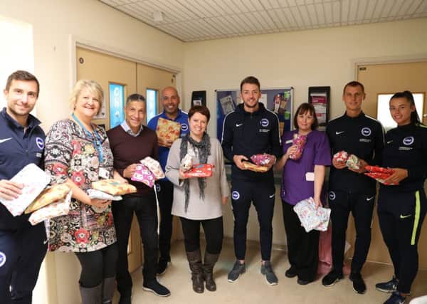 Manager Chris Hughton and some of his Albion players visiting Blue Fin ward at Worthing Hospital
