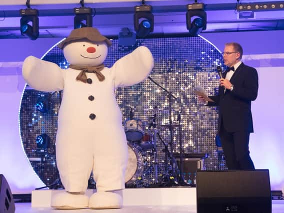 Host Danny Pike with The Snowman at the fundraising ball (Photograph: Graham Franks)