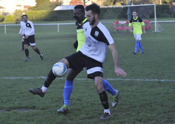 Jack McLean tries to hold off an opponent during Bexhill United's 4-2 win at home to St Francis Rangers on Saturday. Picture by Simon Newstead