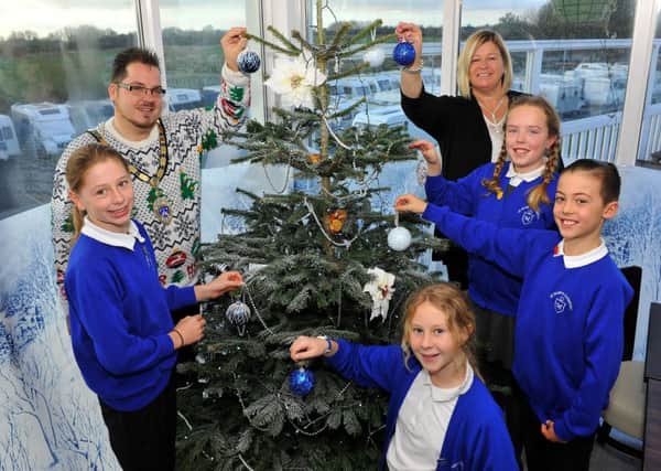 Grace Calloway, Chloe Butterworth, Keira Ahern, Mason Nally from St Mary's Clymping decorating the Christmas Tree at The Boathouse in the Marina, Littlehampton, with owner Julie Fear and Mayor Billy Blanchard-Cooper. Pic Steve Robards