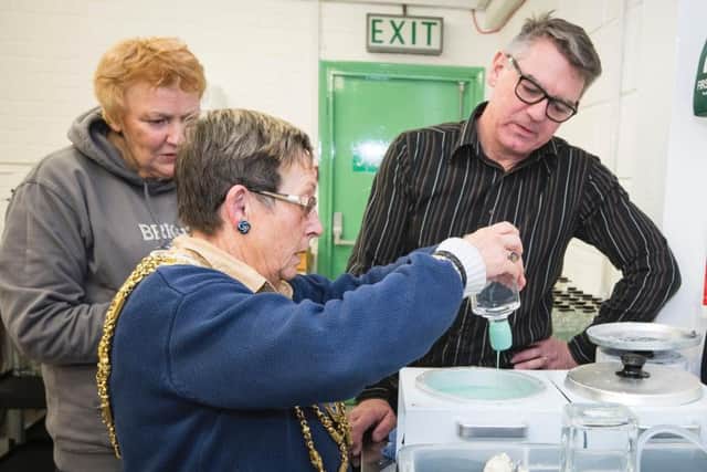 All hands on deck; Mayor Mo Marsh dropped in to help the Brighton Gin team wax bottle seals in the busy Christmas sales period (Photograph: Liz Finlayson/Vervate)