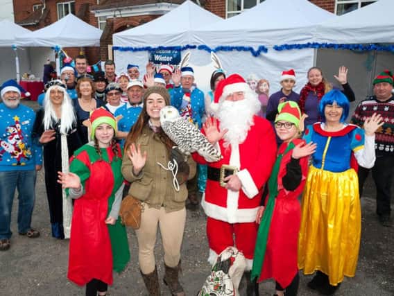 Emily Autumns from Sussex Falconry, Father Christmas and Wick Information Centre manager Julie Roby with some of the volunteers. Pictures: Scott Ramsey