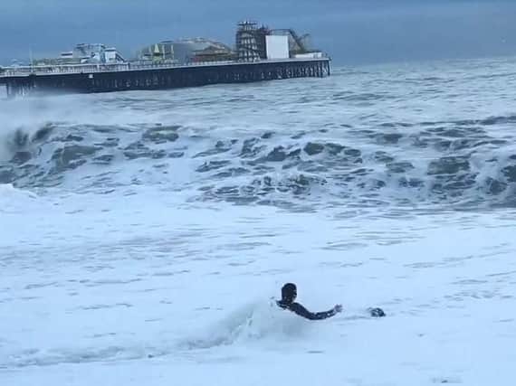 The woman attempting to rescue her dog at Brighton (Credit: Alessando Intini/SWNS)