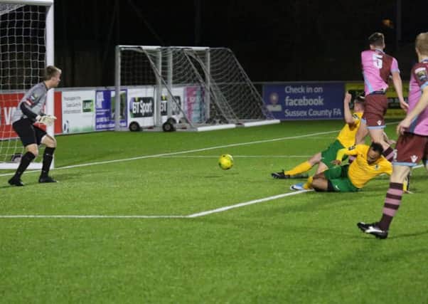 Horsham's Toby House guides home a late consolation goal against Corinthian Casuals. Pictures by John Lines