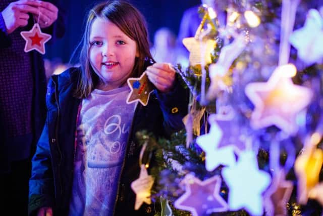 A young girl at the Tree of Light service