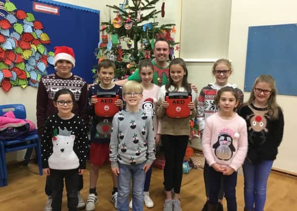 Pupils with both defibrillators. Picture: Northlands Wood Primary Academy